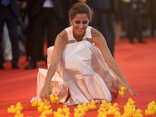 Actor Blu Yoshimi plays with yellow rubber ducks as she arrives at the premiere of the movie Piuma presented in competition at the 73rd Venice Film Festival on September 5. (AFP) Actor Blu Yoshimi plays with yellow rubber ducks as she arrives at the premiere of the movie Piuma presented in competition at the 73rd Venice Film Festival on September 5. (AFP)