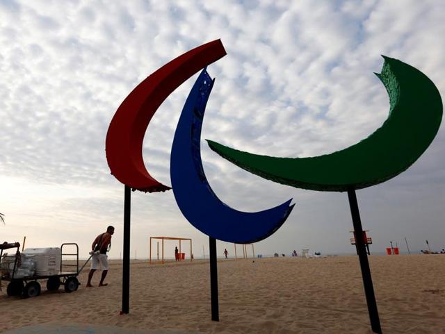 Brazilian soldiers stand guard while people take a selfie in front of the Paralympic symbol.(REUTERS)