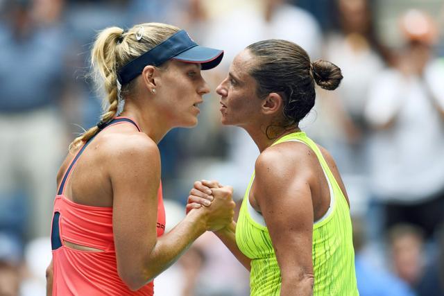 Kerber and Vinci shake hands at the net after the match. (AFP)
