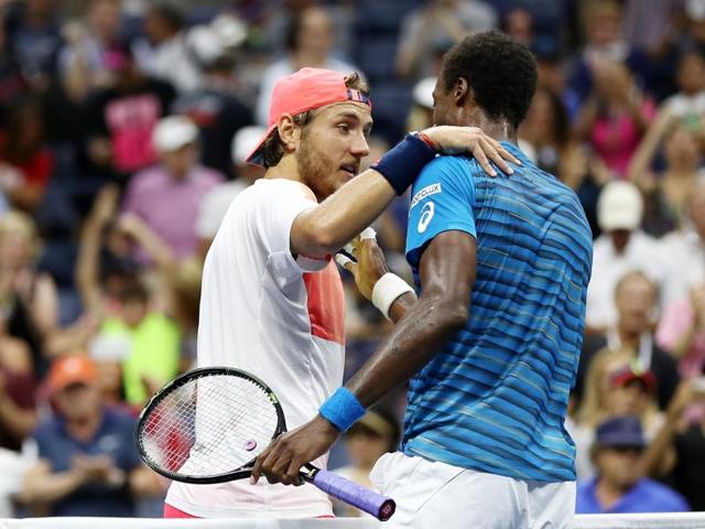 Monfils embraces Pouille at the net after the match. (AFP)
