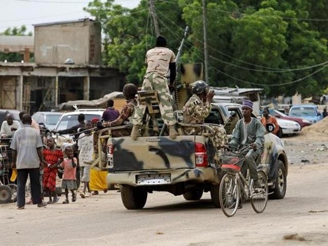 A boy salutes at a military truck in Maiduguri, Borno State, in Nigeria . Picture taken from inside a vehicle. (Reuters) A boy salutes at a military truck in Maiduguri, Borno State, in Nigeria . Picture taken from inside a vehicle. (Reuters)