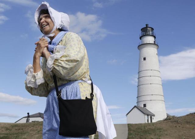 Sally Snowman, the keeper of Boston Light, wears Revolutionary-era clothing as she speaks about its history on Little Brewster Island in Boston Harbour. (AP)