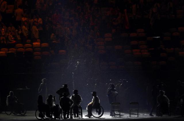 Rain falls on participants during the opening ceremony. (REUTERS) Rain falls on participants during the opening ceremony. (REUTERS)