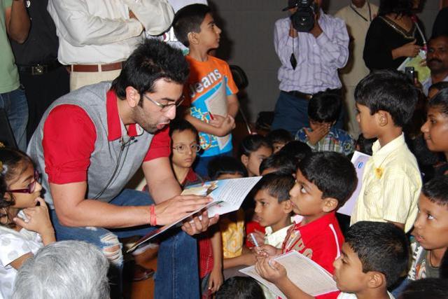 Kids gather around actor Ranbir Kapoor as he reads out from a storybook.