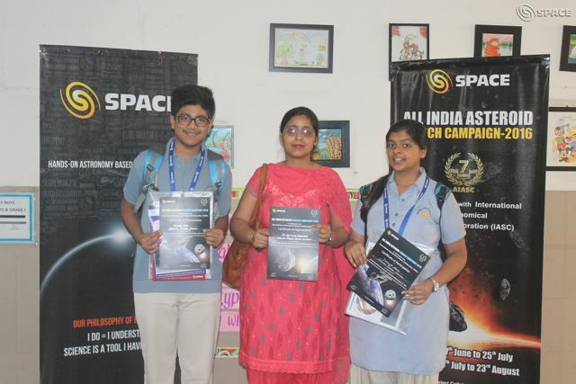 City students Dhruv Gupta and Deshna Jain pose along with their school teacher.