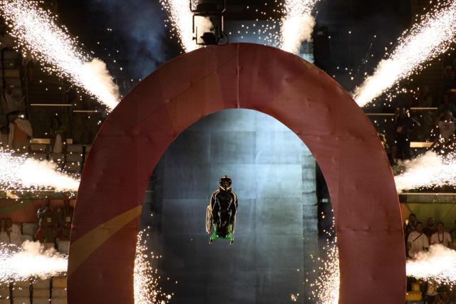 Aaron Wheelz, extreme wheelchair athlete, made a spectacular entrance, breaking through a prop with the number zero, to signify the start of the Games. (AFP) Aaron Wheelz, extreme wheelchair athlete, made a spectacular entrance, breaking through a prop with the number zero, to signify the start of the Games. (AFP)