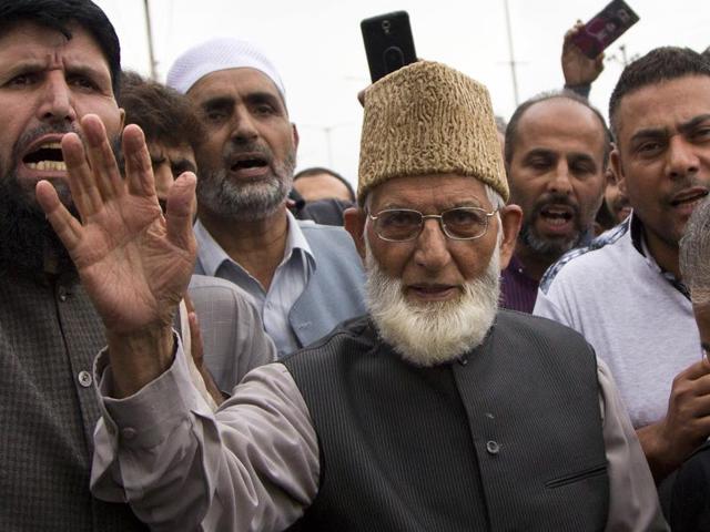 Senior separatist leader of the hardliner faction of All Parties Hurriyat Conference (APHC) Syed Ali Shah Geelani waves to his supporters outside his house in Srinagar. (AP Photo) Senior separatist leader of the hardliner faction of All Parties Hurriyat Conference (APHC) Syed Ali Shah Geelani waves to his supporters outside his house in Srinagar. (AP Photo)