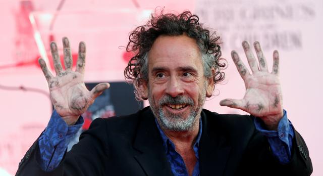 Director Tim Burton shows his hands after placing them in cement during a ceremony in the forecourt of the TCL Chinese theatre in Hollywood. (REUTERS)