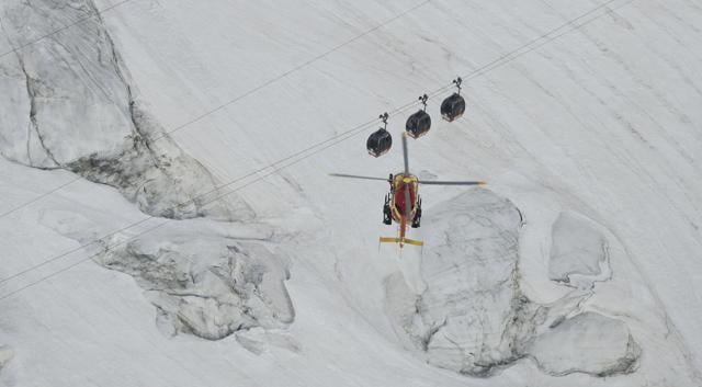 An EC-135 helicopter operated by the French Societe' Civile hovers near three cars of the Panoramic Mont Blanc cable car that stalled around 4 pm. (AP) An EC-135 helicopter operated by the French Societe' Civile hovers near three cars of the Panoramic Mont Blanc cable car that stalled around 4 pm. (AP)