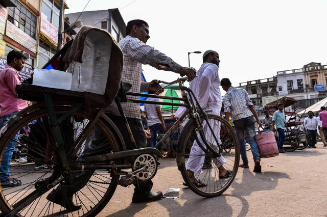 Ram Babu pushes his bicycle laden with blocks of ice. (AFP) Ram Babu pushes his bicycle laden with blocks of ice. (AFP)