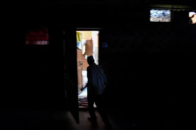 He enters his house after finishing his day of selling ice. (AFP) He enters his house after finishing his day of selling ice. (AFP)