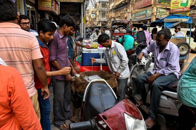 52-year-old Ram Babu chops an ice block into cubes as he sells it in the old quarters of New Delhi. (AFP) 52-year-old Ram Babu chops an ice block into cubes as he sells it in the old quarters of New Delhi. (AFP)