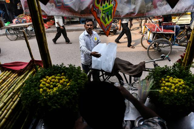 He sells ice to roadside vendors. (AFP) He sells ice to roadside vendors. (AFP)