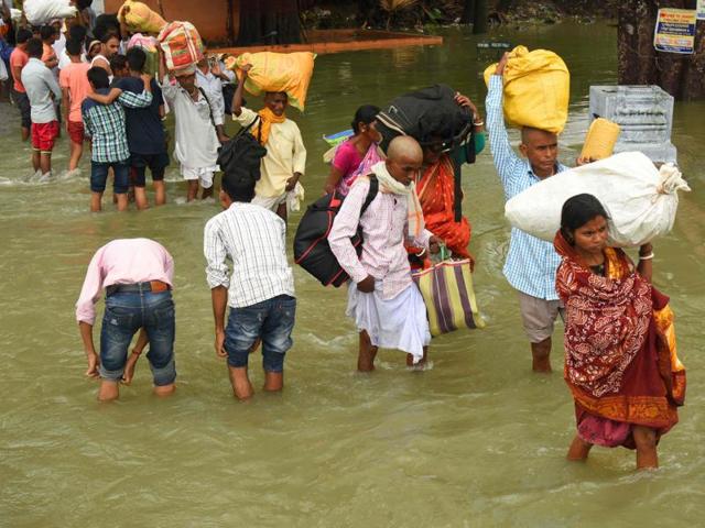 Residents carry their belongings as they walk through the flooded Pant Nagar area of Gaya after incessant monsoon rains flooded Bihar. (AFP Photo) Residents carry their belongings as they walk through the flooded Pant Nagar area of Gaya after incessant monsoon rains flooded Bihar. (AFP Photo)