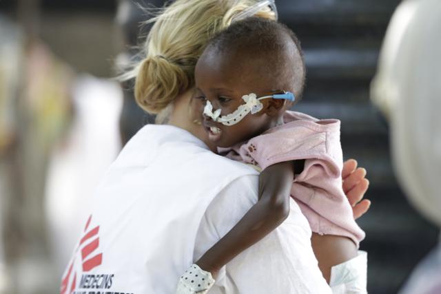 In this photo taken Monday Aug. 29, 2016 Jean Stowell, an American doctor from Loconia, New Hampshire, running the emergency operation, carries 18 month old Yakubu a malnourished child at a feeding centre run by Doctors Without Borders in Maiduguri, Nigeria. (AP) In this photo taken Monday Aug. 29, 2016 Jean Stowell, an American doctor from Loconia, New Hampshire, running the emergency operation, carries 18 month old Yakubu a malnourished child at a feeding centre run by Doctors Without Borders in Maiduguri, Nigeria. (AP)