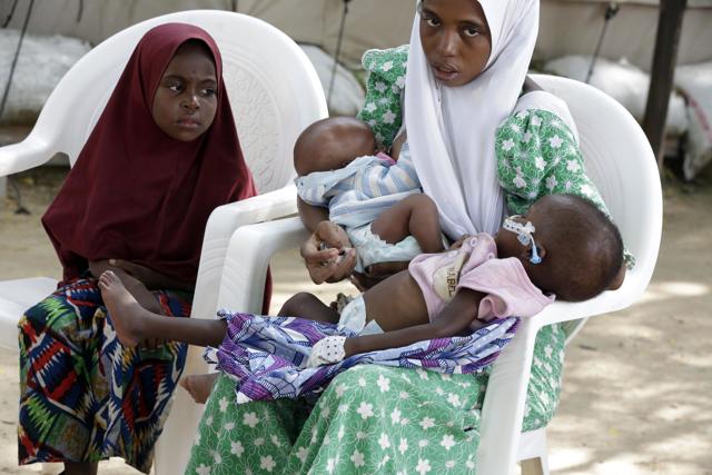Hassana Mohammed, tries to breast feed her baby while comforting her malnourished son 18- Month Yakubu, at a feeding centre run by Doctors Without Borders in Maiduguri, Nigeria. (AP) Hassana Mohammed, tries to breast feed her baby while comforting her malnourished son 18- Month Yakubu, at a feeding centre run by Doctors Without Borders in Maiduguri, Nigeria. (AP)