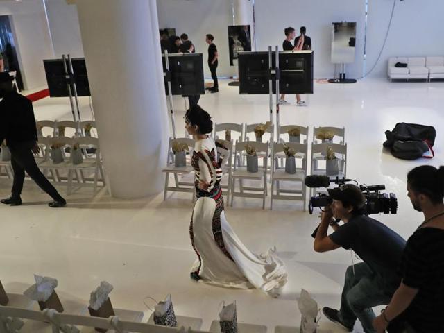Model and acid attack victim Reshma Qureshi rehearses before walking the runway.  She walked the runway to send a message of courage and empowerment to other victims of such attacks in India. (AP) 