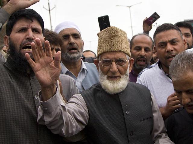 Separatist leader of the hardliner faction of All Parties Hurriyat Conference Syed Ali Shah Geelani waves to his supporters outside his house as he arrives to participate in a march towards an army base in Srinagar.(AP) Separatist leader of the hardliner faction of All Parties Hurriyat Conference Syed Ali Shah Geelani waves to his supporters outside his house as he arrives to participate in a march towards an army base in Srinagar.(AP)