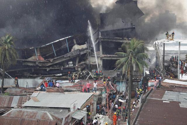 Firefighters and local people work together to put out the fire at a packaging factory in Tongi industy area outside Dhaka. (AP) Firefighters and local people work together to put out the fire at a packaging factory in Tongi industy area outside Dhaka. (AP)
