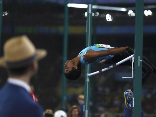 An official watches Varun Singh Bhati’s jump. (REUTERS)