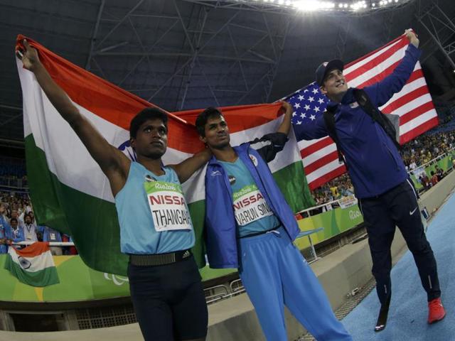 Gold medallist Mariyappan Thangavelu,bronze medal winner Varun Singh Bhati and silver medallist Sam Grewe of the United States celebrate their wins. (REUTERS)