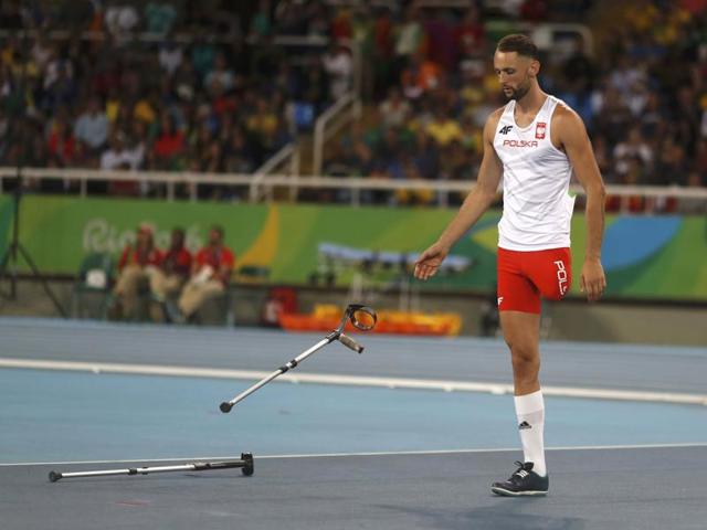 Lukasz Mamczarz of Poland discards his crutches before an attempt. (REUTERS)