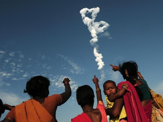 Bystanders look on as Indian Space Research Organisation's (ISRO) satellite INSAT-3DR, on board the Geosynchronous Satellite Launch Vehicle (GSLV-F05), launches from Sriharikota on September 8, 2016.  (AFP) 