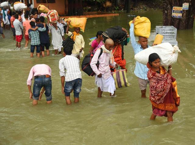 People carry their belongings as they walk through the flooded Pant Nagar area of Gaya. (AFP Photo) People carry their belongings as they walk through the flooded Pant Nagar area of Gaya. (AFP Photo)