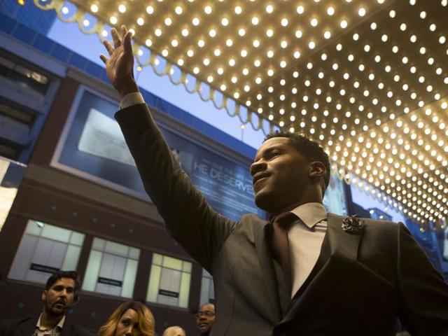 Director Nate Parker waves as he arrives on the red carpet for the film The Birth of a Nation amid controversy surrounding his 1999 rape case. (AP) Director Nate Parker waves as he arrives on the red carpet for the film The Birth of a Nation amid controversy surrounding his 1999 rape case. (AP)