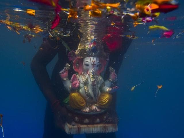An idol of elephant-headed Hindu god Ganesha floats after it was immersed in an artificial pond during Ganesh Visarjan at Sion in Mumbai, India, on Tuesday, September 6, 2016. (Satish bate/HT photo) 