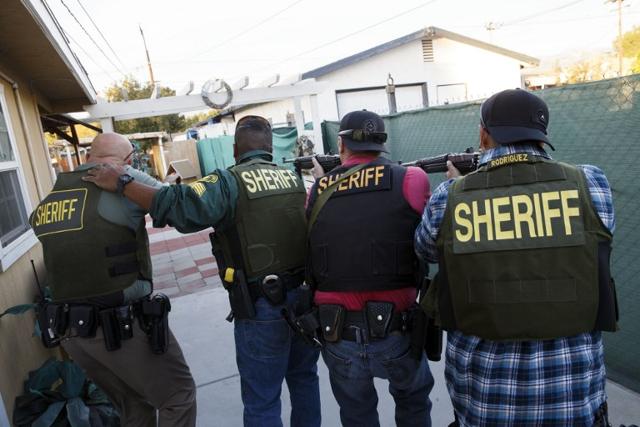 Law enforcement officers search for the suspects of a mass shooting December 2, 2015 in San Bernardino, California. (AFP) Law enforcement officers search for the suspects of a mass shooting December 2, 2015 in San Bernardino, California. (AFP)