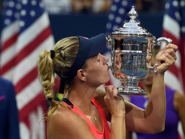 Kerber kisses her championship trophy as she poses for photographs. (AFP) Kerber kisses her championship trophy as she poses for photographs. (AFP)