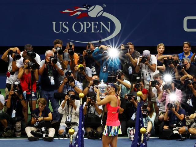 Kerber kisses her trophy as photographers take pictures. (AFP) Kerber kisses her trophy as photographers take pictures. (AFP)