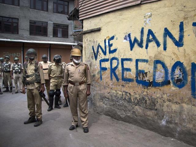 Policemen stand guard during a curfew in Srinagar, as Kashmir enters a third month of tense conflict marked by violent street clashes and almost daily protests.(AP)