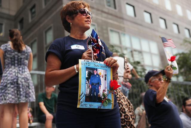 Family members of fallen officers watch a procession in Lower Manhattan to mark the 15th anniversary of the 9/11 attacks. (AFP)