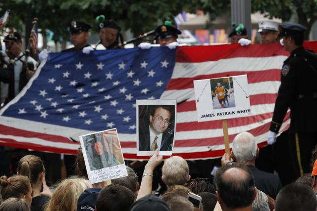 Mourners hold photos of their loved ones during the 15th anniversary celebration of the attacks of the World Trade Center at the National September 11 Memorial in New York. (AP Photo) Mourners hold photos of their loved ones during the 15th anniversary celebration of the attacks of the World Trade Center at the National September 11 Memorial in New York. (AP Photo)