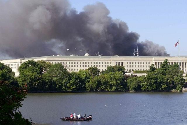 Fishermen on a boat watch smoke rising from the Pentagon in Washington 11 September 2001. (AFP) Fishermen on a boat watch smoke rising from the Pentagon in Washington 11 September 2001. (AFP)