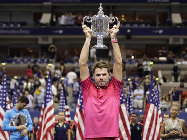 Stan Wawrinka, of Switzerland, holds up the US Open championship trophy. (AP Photo)