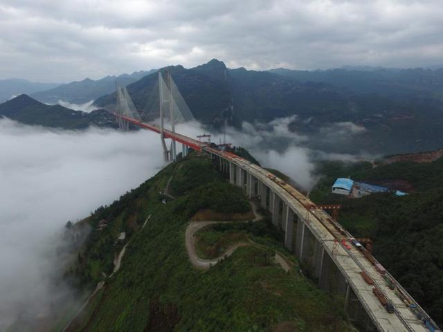 Workers complete a bridge that connects two provinces in China’s Guizhou Province, on September 10, 2016. At 565 m above a river, it is the world’s highest bridge. (Reuters) Workers complete a bridge that connects two provinces in China’s Guizhou Province, on September 10, 2016. At 565 m above a river, it is the world’s highest bridge. (Reuters)