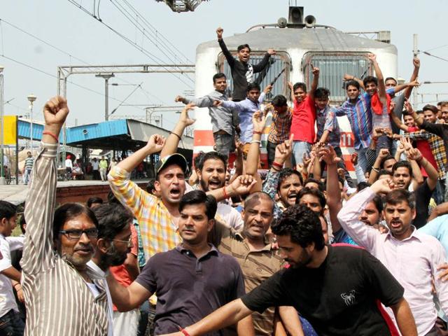 The protesters raising slogans in front of a train that was stopped on Monday. (JS Grewal/HT Photo )