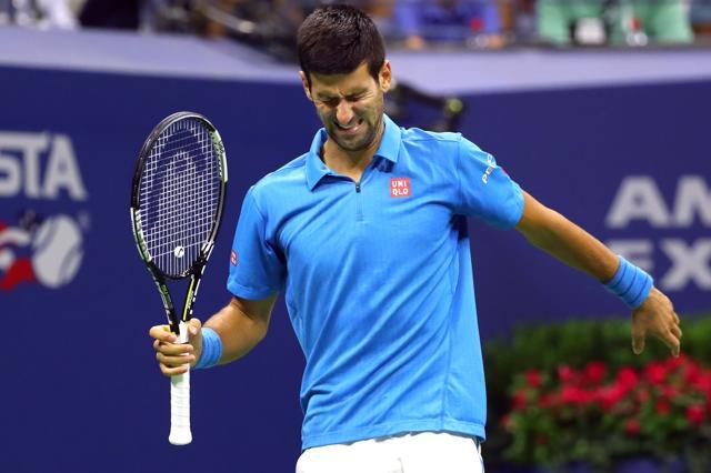 Novak Djokovic of Serbia grimaces after taking medical time to check a toe injury. (AFP Photo)