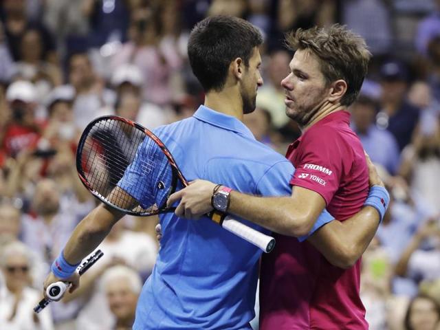 Stan Wawrinka, of Switzerland, right, hugs Novak Djokovic, of Serbia, at the net. (AP photo)