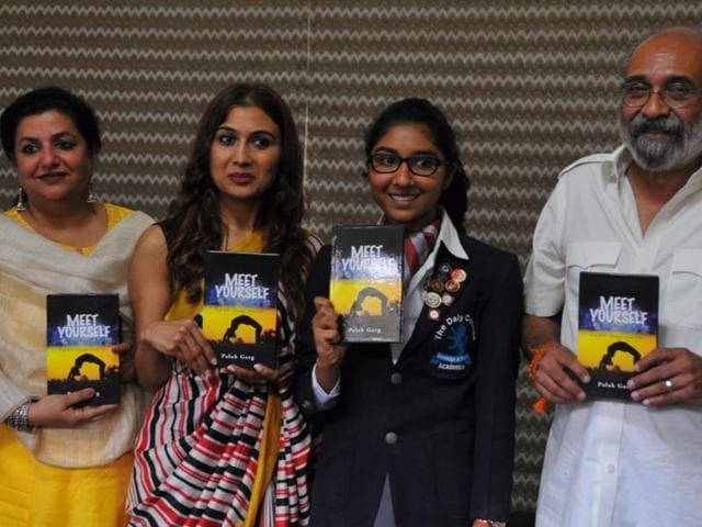 Palak Garg (second from right) releases her book “Meet Yourself” at Daly College in Indore on Monday.(Shankar Mourya/ HT photo)