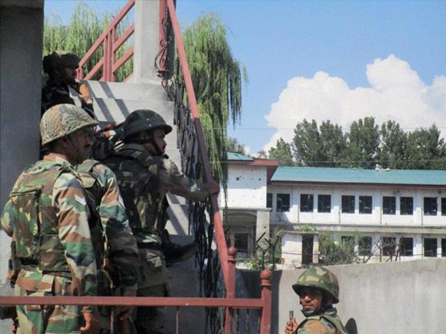 Security personnel take positions near the building where militants were hiding during the second day of encounter at Allah Pir area in Poonch on Monday.(PTI) Security personnel take positions near the building where militants were hiding during the second day of encounter at Allah Pir area in Poonch on Monday.(PTI)