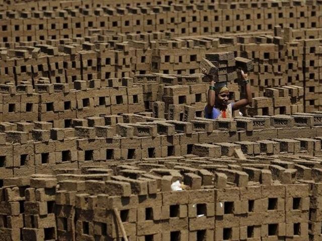 A labourer carries bricks at a kiln in Karjat. (Reuters) A labourer carries bricks at a kiln in Karjat. (Reuters)
