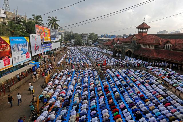 People offer Eid al-Adha prayers on a street outside a railway station in Mumbai. (REUTERS)