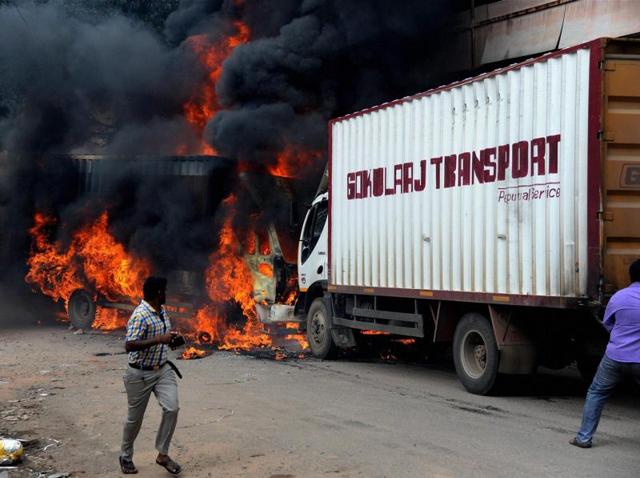 A vehicle from Tamil Nadu in flames after it was torched by pro-Kannada activists during a protest over Cauvery water row, in Bengaluru. (PTI Photo) A vehicle from Tamil Nadu in flames after it was torched by pro-Kannada activists during a protest over Cauvery water row, in Bengaluru. (PTI Photo)