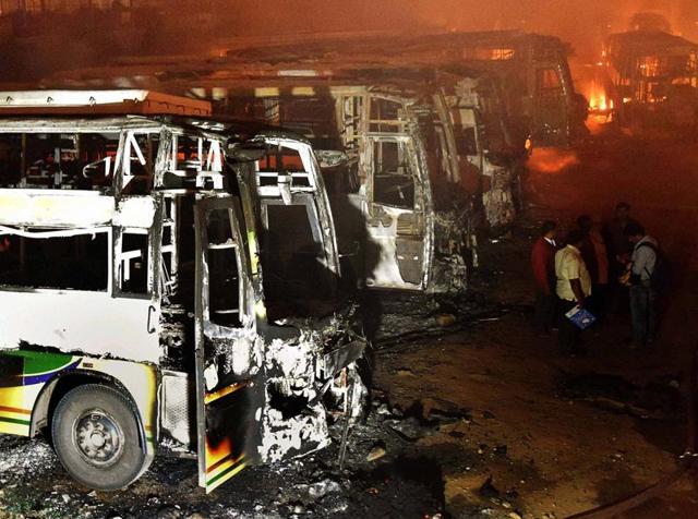 Remains of Tamil Nadu-bound buses set ablaze by protesters in Bengaluru. (PTI) Remains of Tamil Nadu-bound buses set ablaze by protesters in Bengaluru. (PTI)