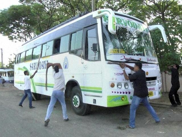 Tamil activists vandalise a bus from Karnataka as they protest over Cauvery water row, in Rameshwaram. (PTI Photo) 
