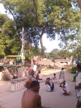 Villagers in Bidhiya watch the electricity poles being erected. (HT photo) Villagers in Bidhiya watch the electricity poles being erected. (HT photo)